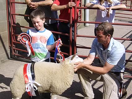 Harry Bouch with father Paul Bouch with the Champion young handlers lamb