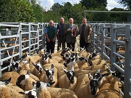 Champion Pen of Scotch Mule Ewe Lambs which topped at £130. R to L David Bryson (Sponsor), Stuart Park, John Kerr (Judge), John Park